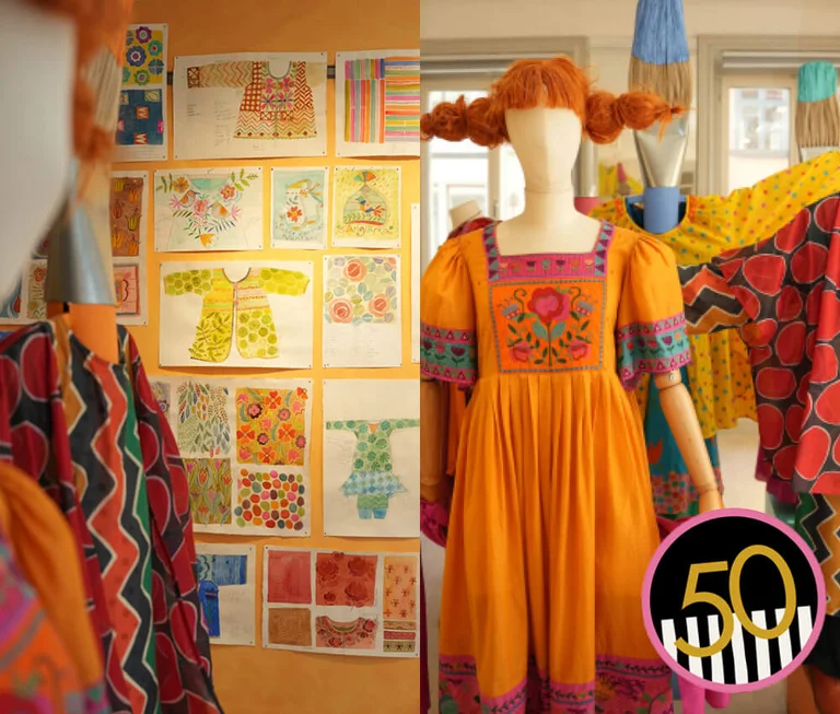 A mannequin dressed in an orange dress with embroidery from Gudrun Sjödén.