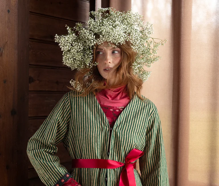 A woman wearing a patterned jacket from Gudrun Sjödén. 