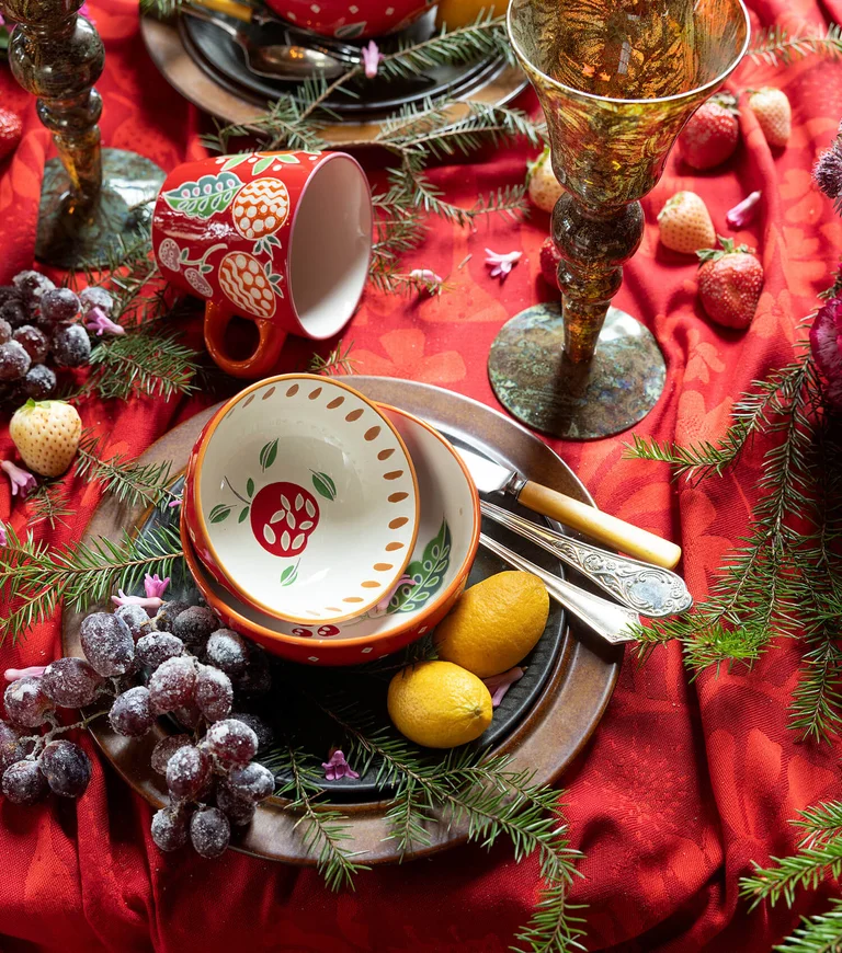 A table with hand-painted ceramic items from Gudrun Sjödén. 