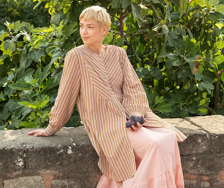 A woman wearing a striped dress from Gudrun Sjödén. 