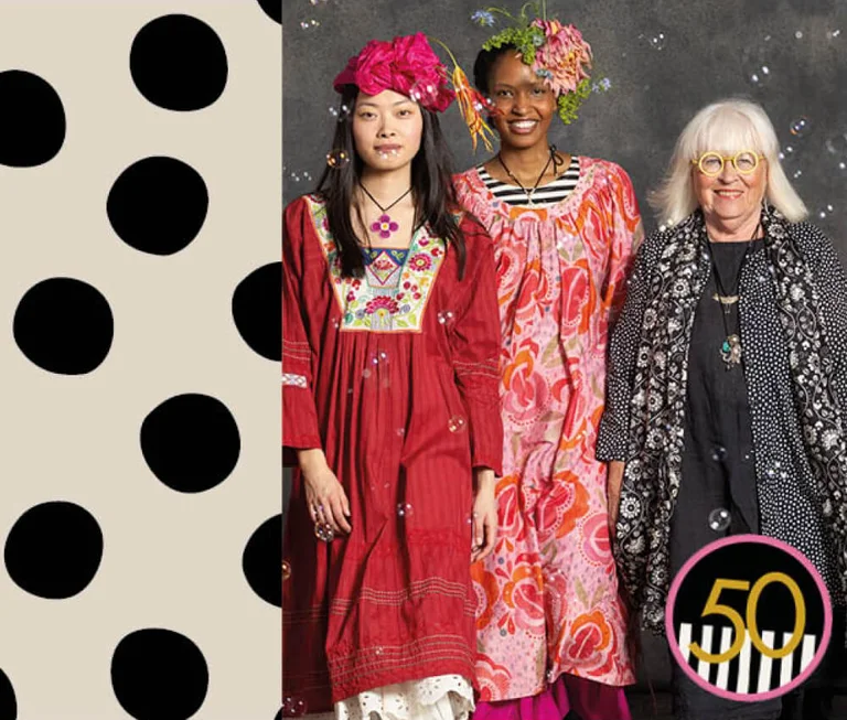 Three women wearing patterned creations from Gudrun Sjödén.