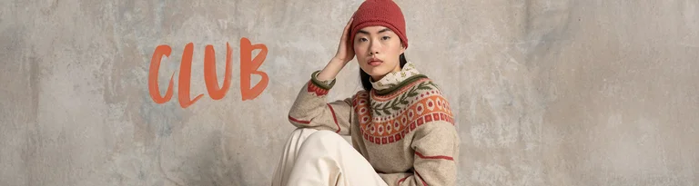 A woman in a patterned knitted jumper and red beanie sits against a neutral background with the text "CLUB" in red.