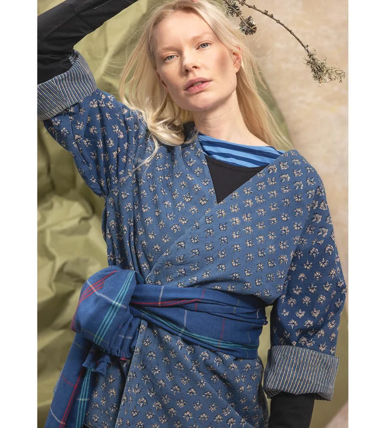 A close-up of a woman wearing clothes in shades of blue from Gudrun Sjödén’s “Natural dyes” collection.