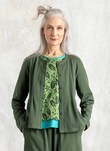 A woman wearing a striped jersey top from Gudrun Sjödén.