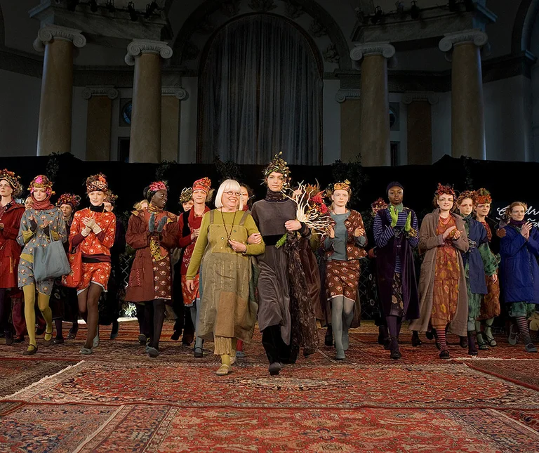 A fashion show with women wearing Gudrun Sjödén clothes.