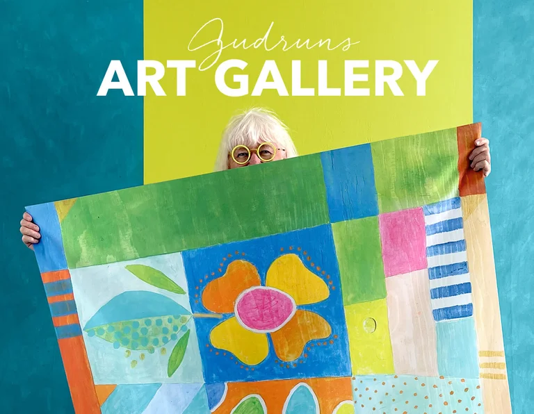 Gudrun Sjödén is holding one of her paintings. 