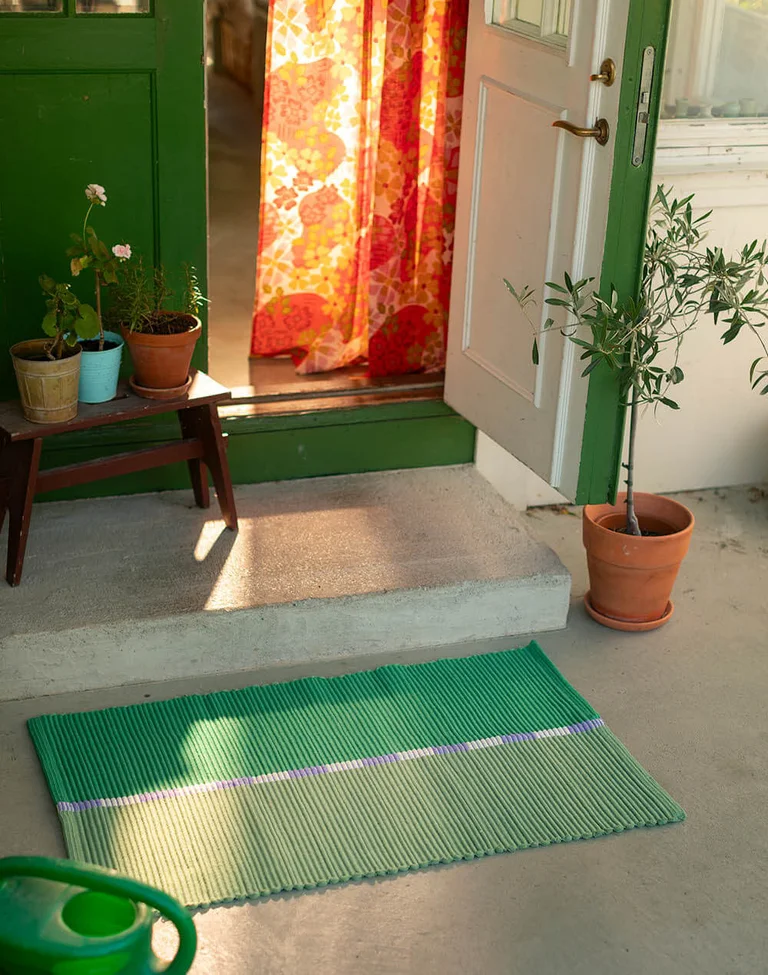 A home interior featuring soft furnishings in bright colours from Gudrun Sjödén.
