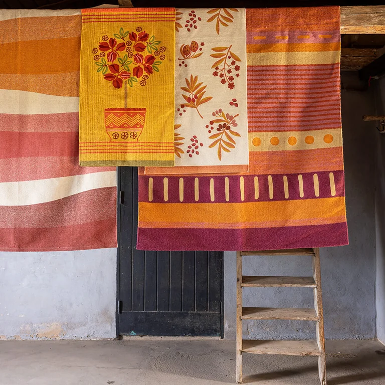 Rugs and mats in warm colours from Gudrun Sjödén. 