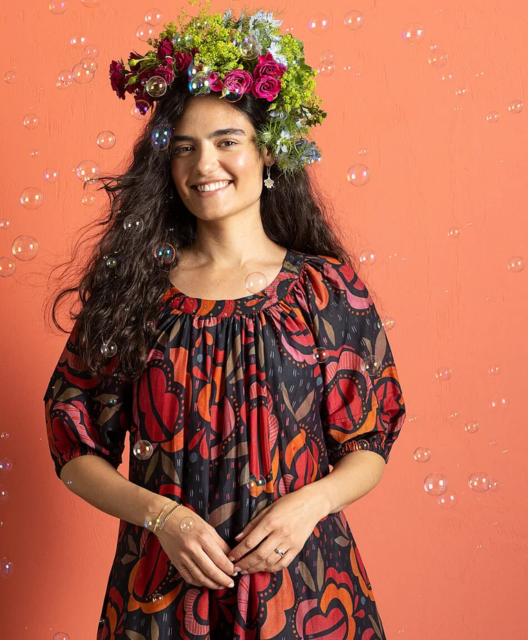 A woman wearing a patterned dress from Gudrun Sjödén. 