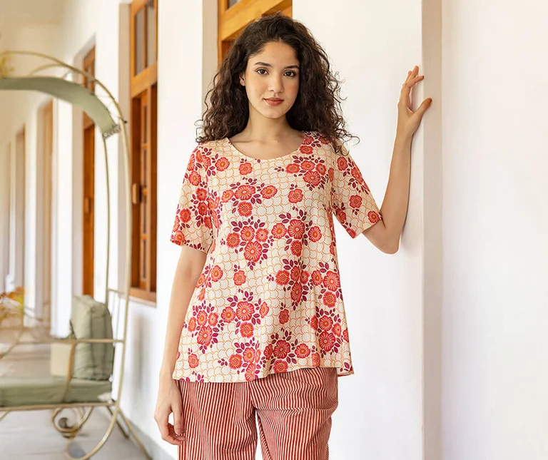 A woman wearing a floral top from Gudrun Sjödén.