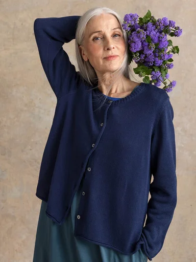 A woman wearing red and pink knitwear from Gudrun Sjödén.