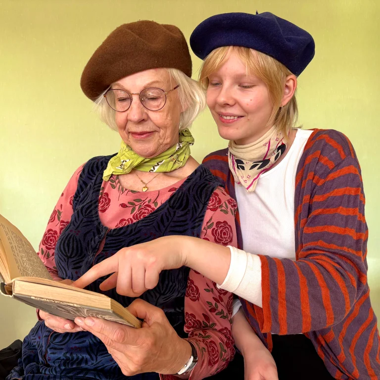 Two women dressed in Paris-inspired clothing such as berets and striped sweaters.