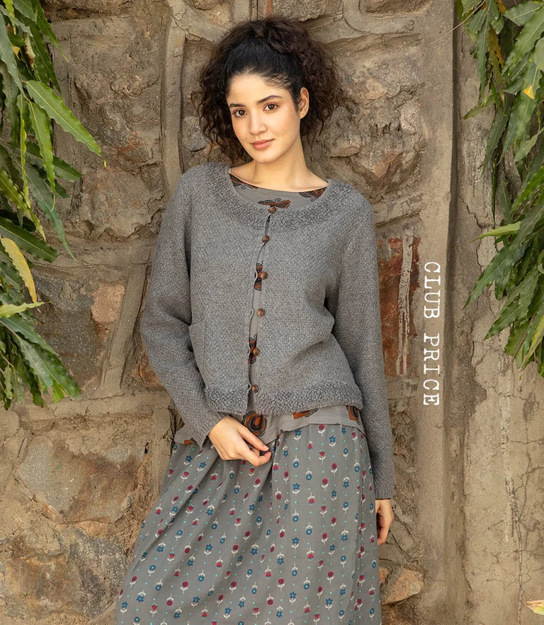 A woman wearing layers of grey clothes from Gudrun Sjödén.