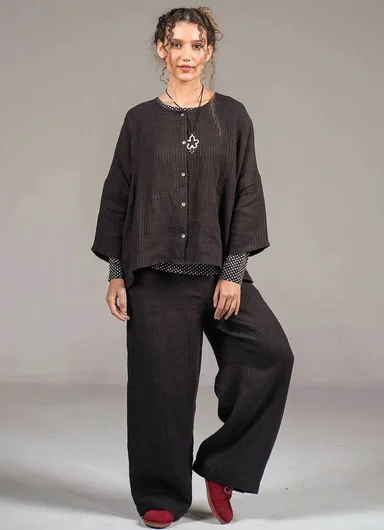 A woman wearing layers of woven clothes from Gudrun Sjödén.