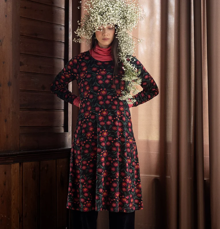 A woman wearing a floral dress from Gudrun Sjödén. 