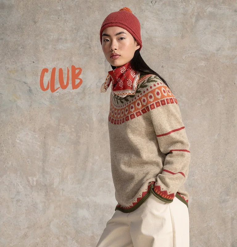 A woman wearing a patterned knit sweater from Gudrun Sjödén.