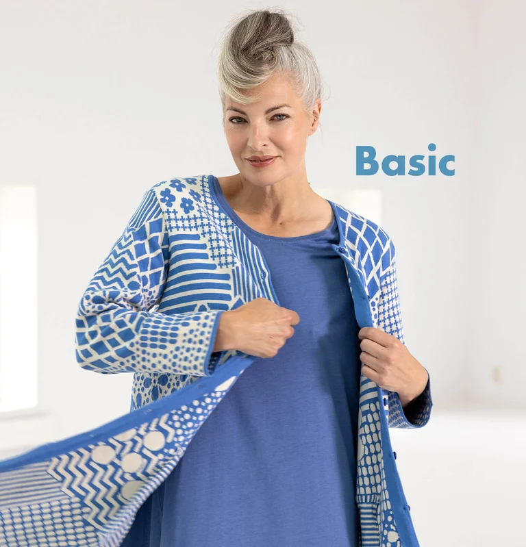 A woman wearing a patterned cardigan from Gudrun Sjödén’s Essentials collection.