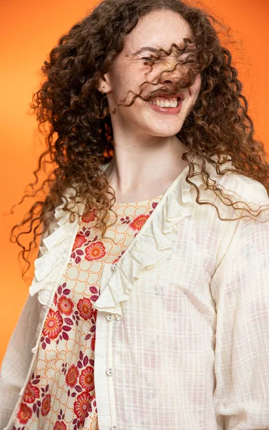 A woman wearing a blouse from Gudrun Sjödén.