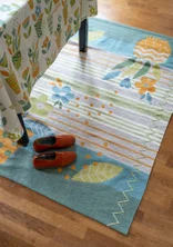 “Flower Bed” embroidered rug in organic cotton - celadon
