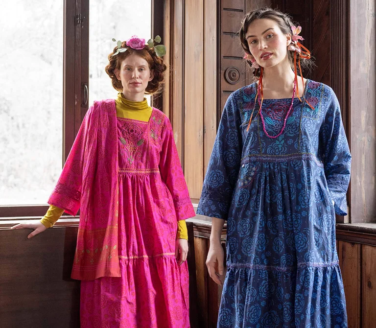 Two women wearing floral dresses from Gudrun Sjödén. 