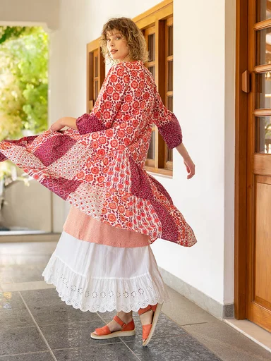 A woman wearing white and pink clothes from Gudrun Sjödén.