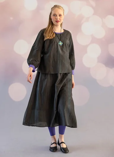 Two women wearing lustrous, pink pieces from Gudrun Sjödén’s Festive Shimmer collection.